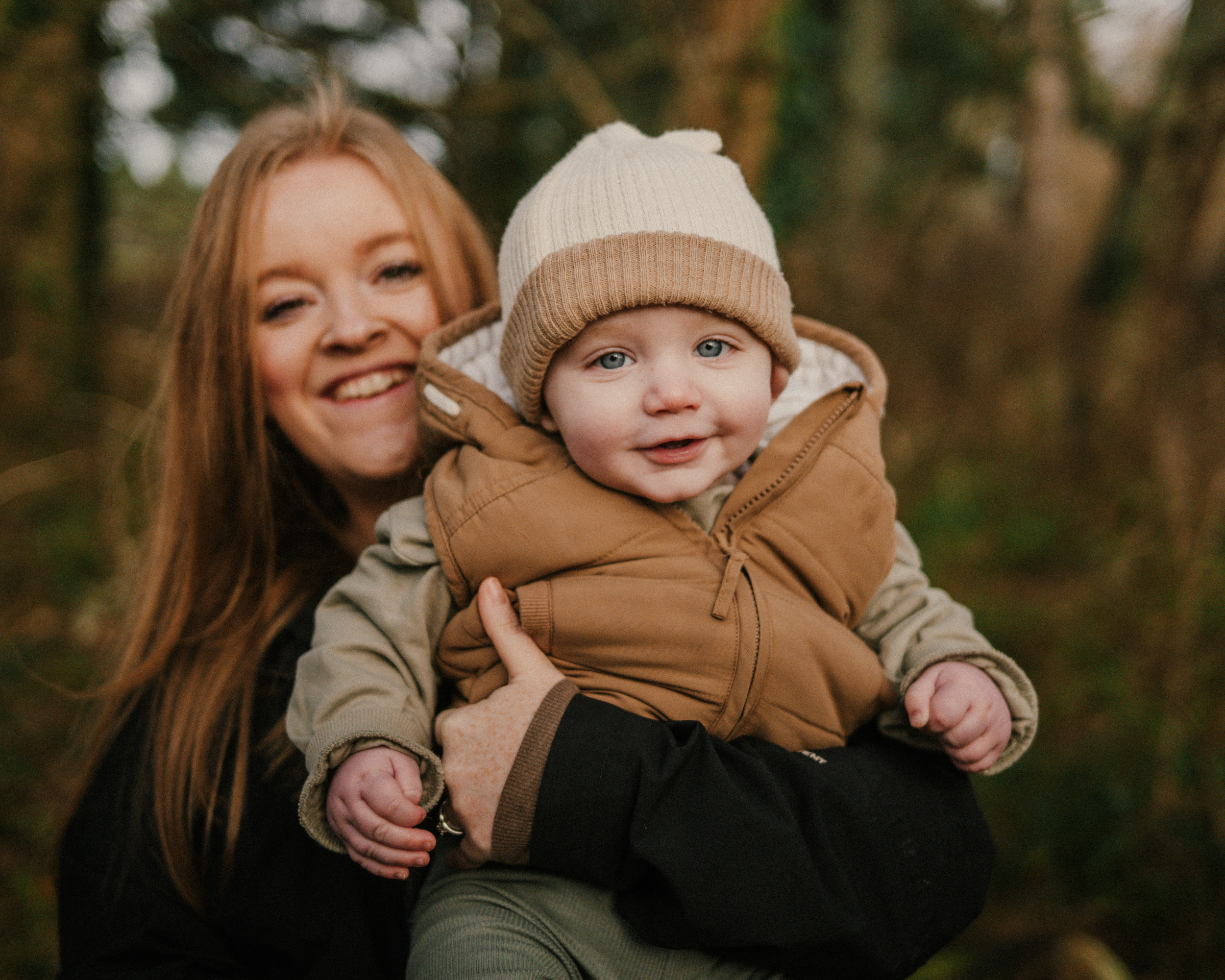 Mother holding smiling baby.