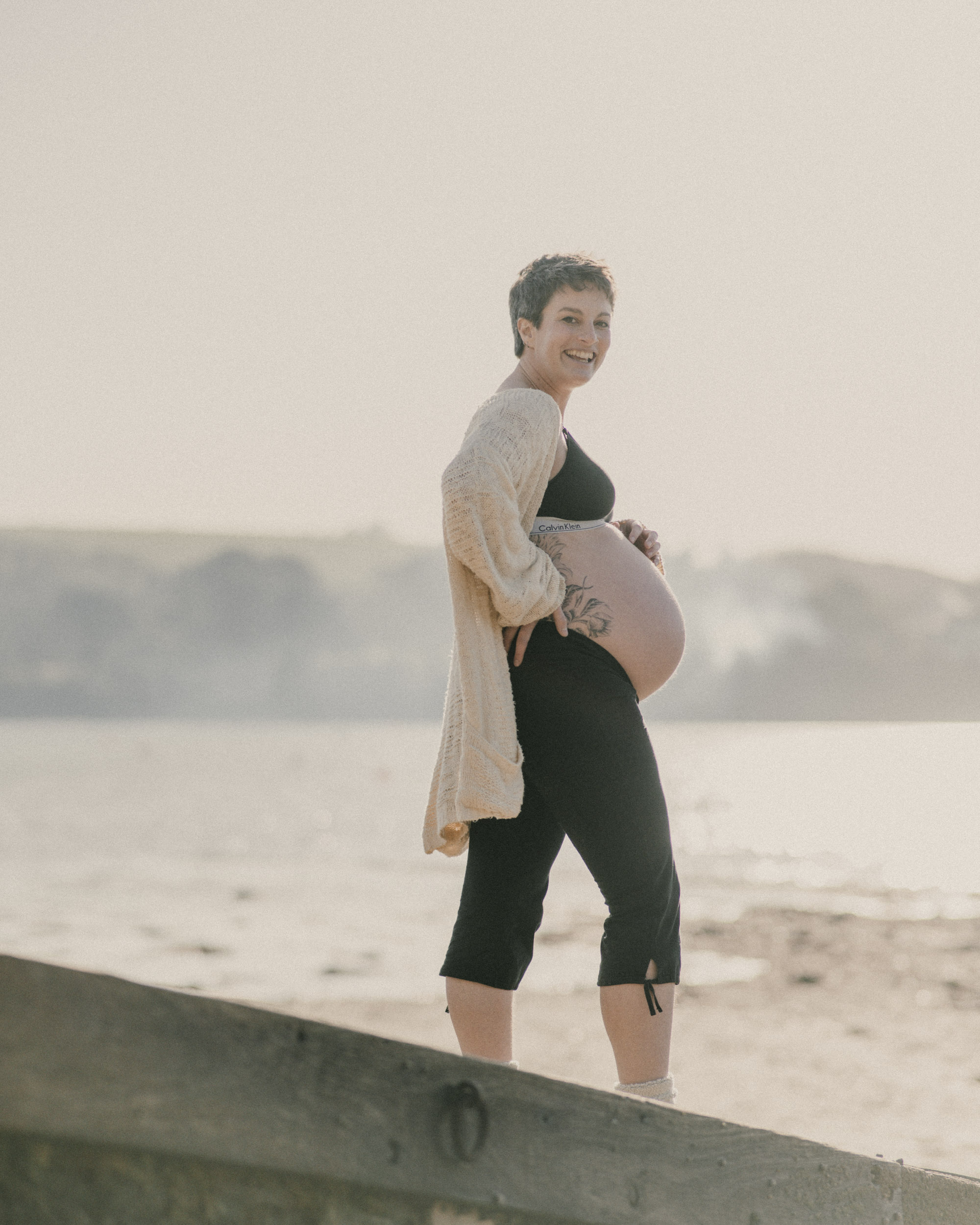 Pregnant women smiling on Beach in Falmouth