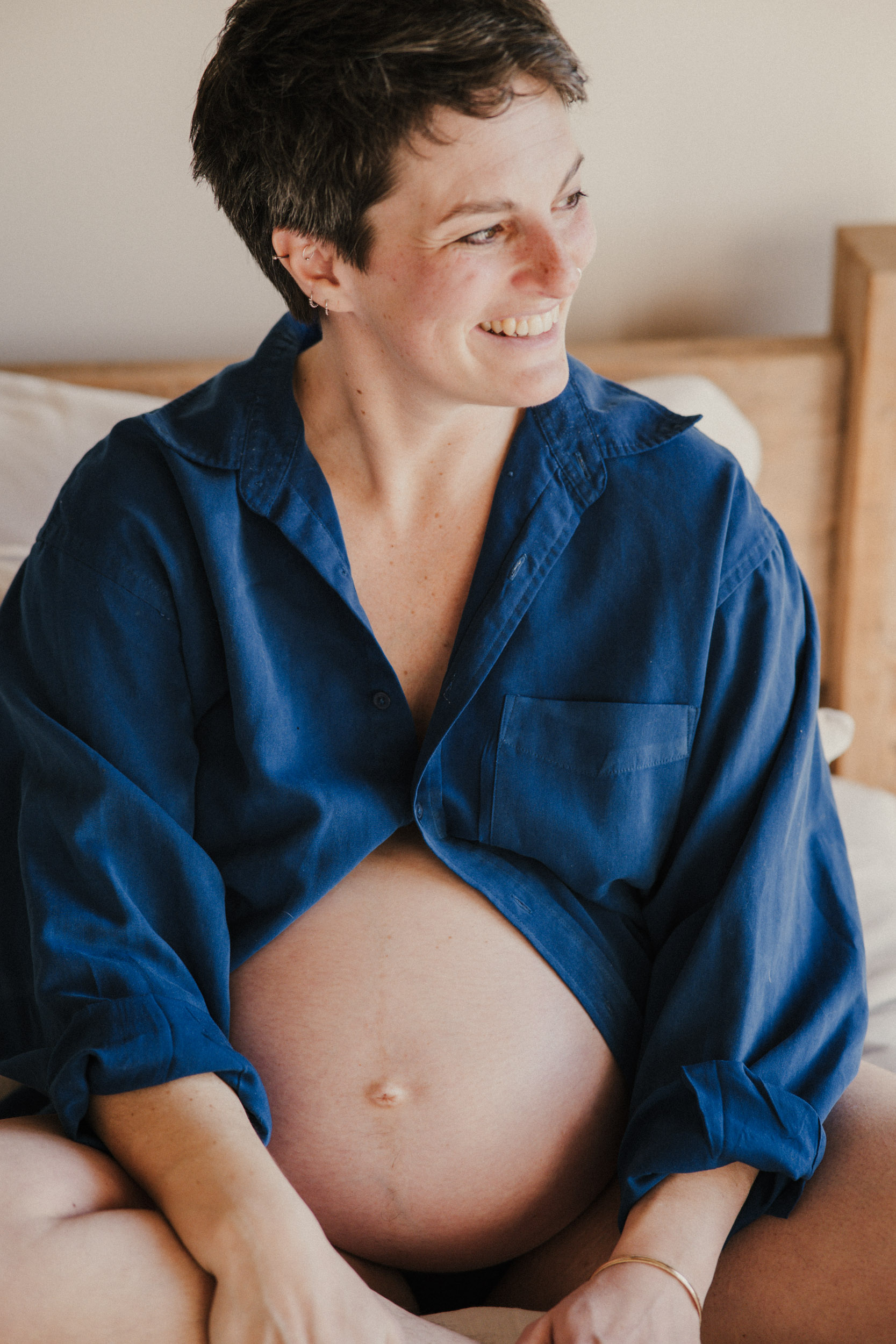 pregnant women in blue shirt on bed in Cornwall