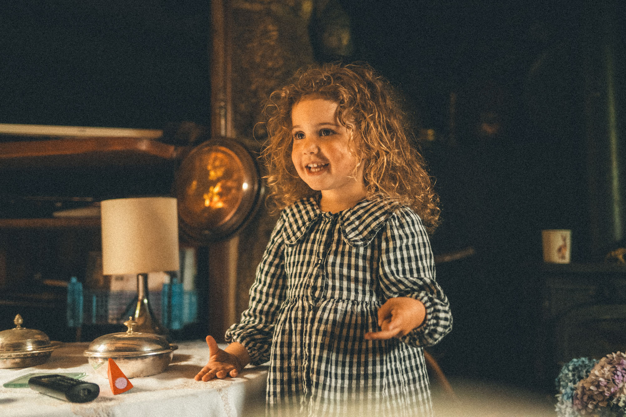 Animated young girl standing beside the table in her family home near St Ives