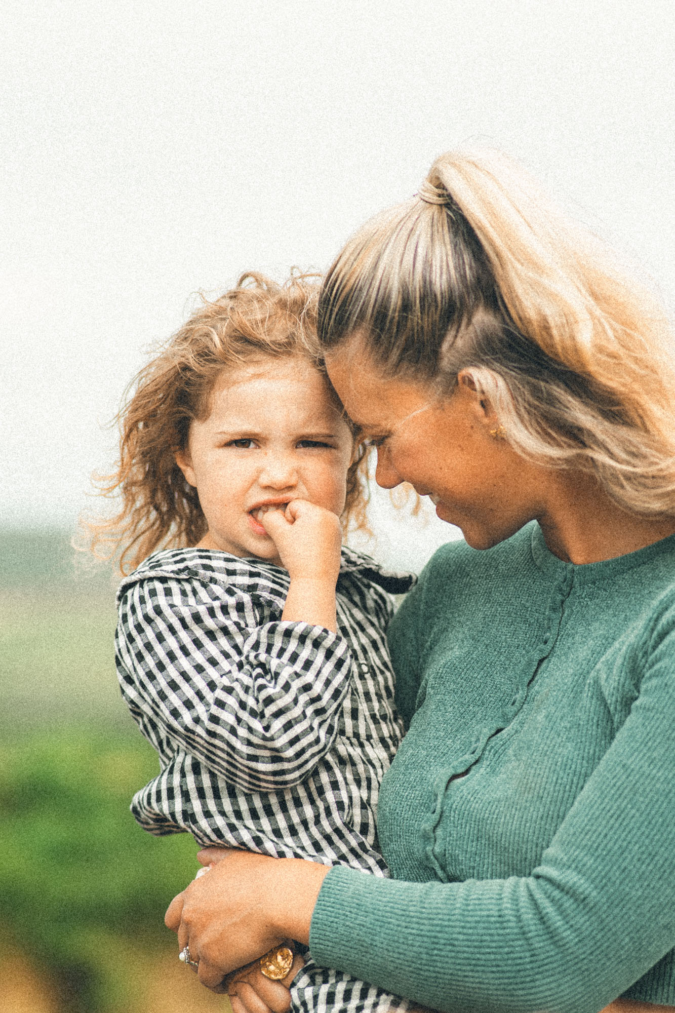 Mother holding her young daughter during a natural family photography session near St Ives